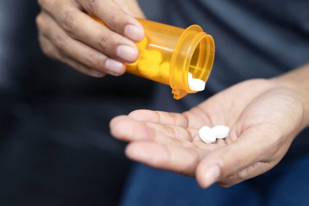 Illustration of opioid use disorder statistics and the impact on individuals and communities.