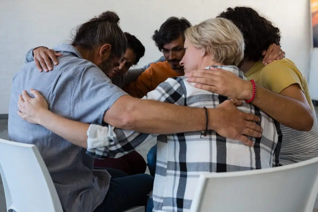 Family members supporting a loved one during a recovery session.