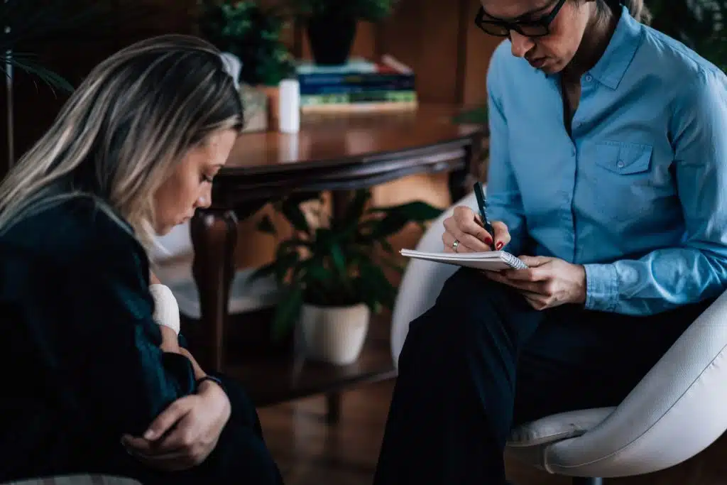 Illustration of Cognitive Behavioral Therapy (CBT), showing a therapist and client working together to identify and change negative thought patterns.