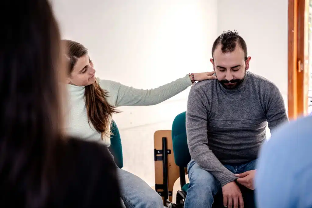 Family providing emotional support to a loved one in rehab