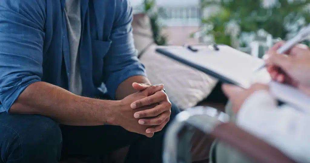 A person researching and discussing options for choosing a rehab center