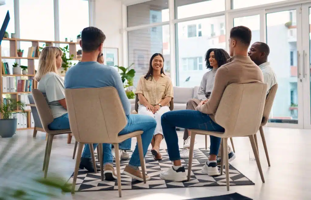 A support group meeting where individuals share their recovery experiences and progress