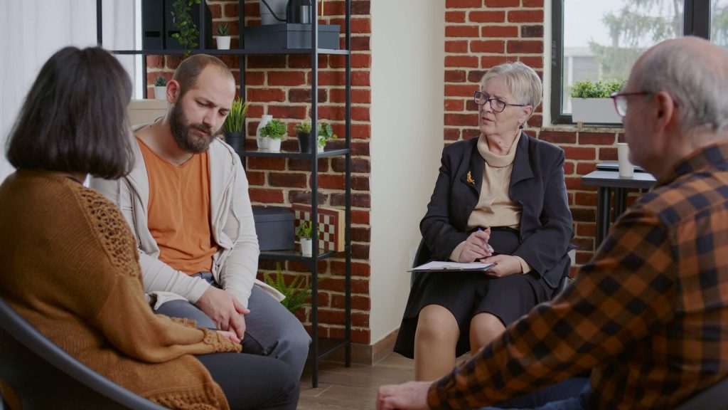 Family therapy session in a rehab center, where family members engage in conversations to support the recovery process of their loved one.