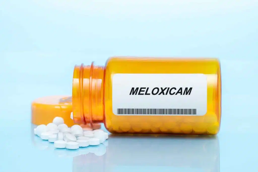 Meloxicam pill bottle and tablets - non-addictive NSAID for pain and inflammation