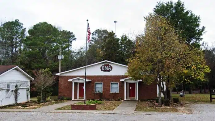 Entrance sign and building facade of OMA – Outreach Ministries of Alabama in Valhermoso Springs, AL 35775