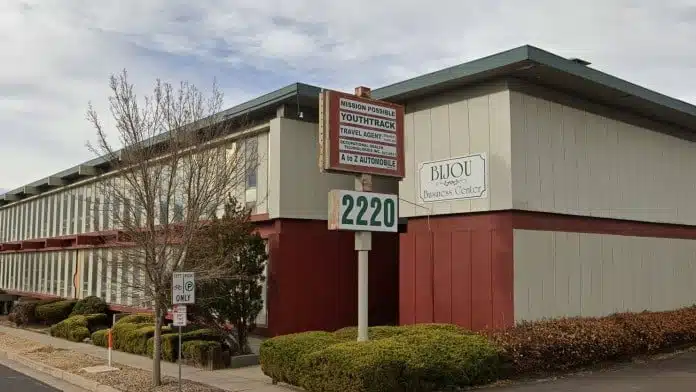 Front entrance of Swanson Counseling in Colorado Springs, CO, with signage and greenery