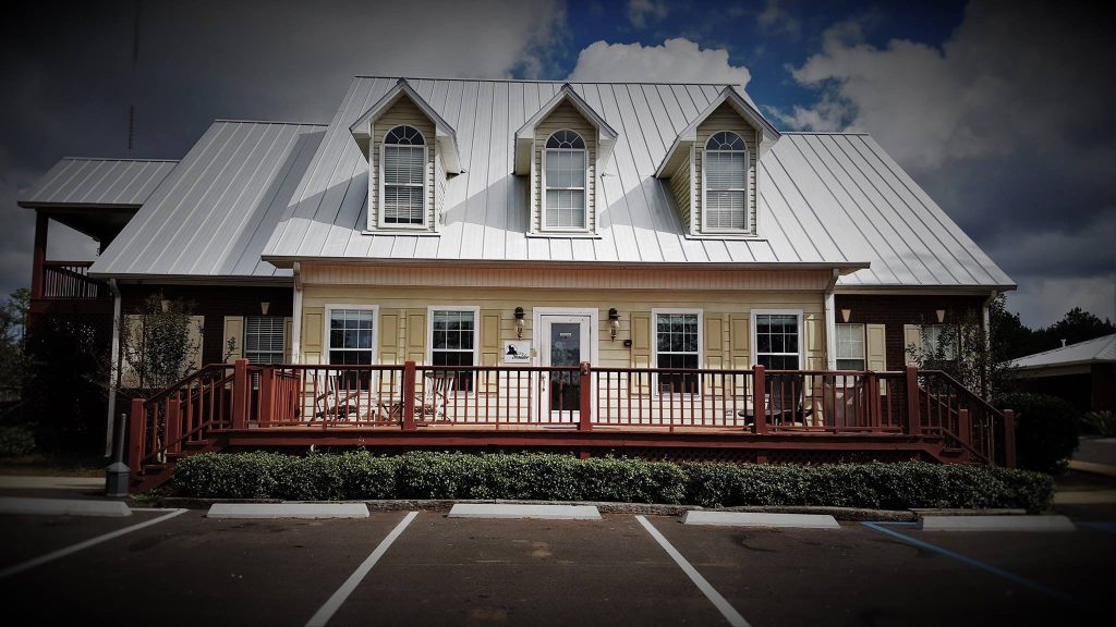 Front exterior of The Shoulder recovery center in Spanish Fort, AL, showing the building facade and entryway.