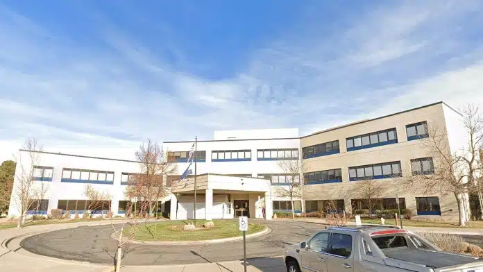 Front entrance of Highlands Behavioral Health System in Littleton, Colorado, showing accessible pathways and facility signage