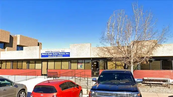 Front entrance of New Beginnings Recovery Center in Littleton, Colorado, showing accessible pathways and facility signage