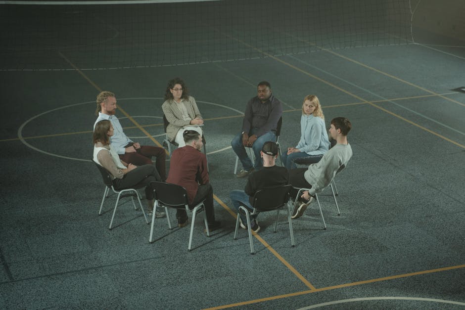 Diverse group of people in a supportive group setting - Alcohol Addiction Rehab Centers