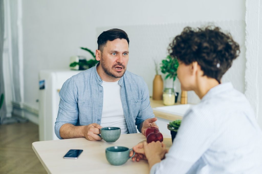 A man engaged in a one-on-one therapy session with a counselor - Men's inpatient rehab
