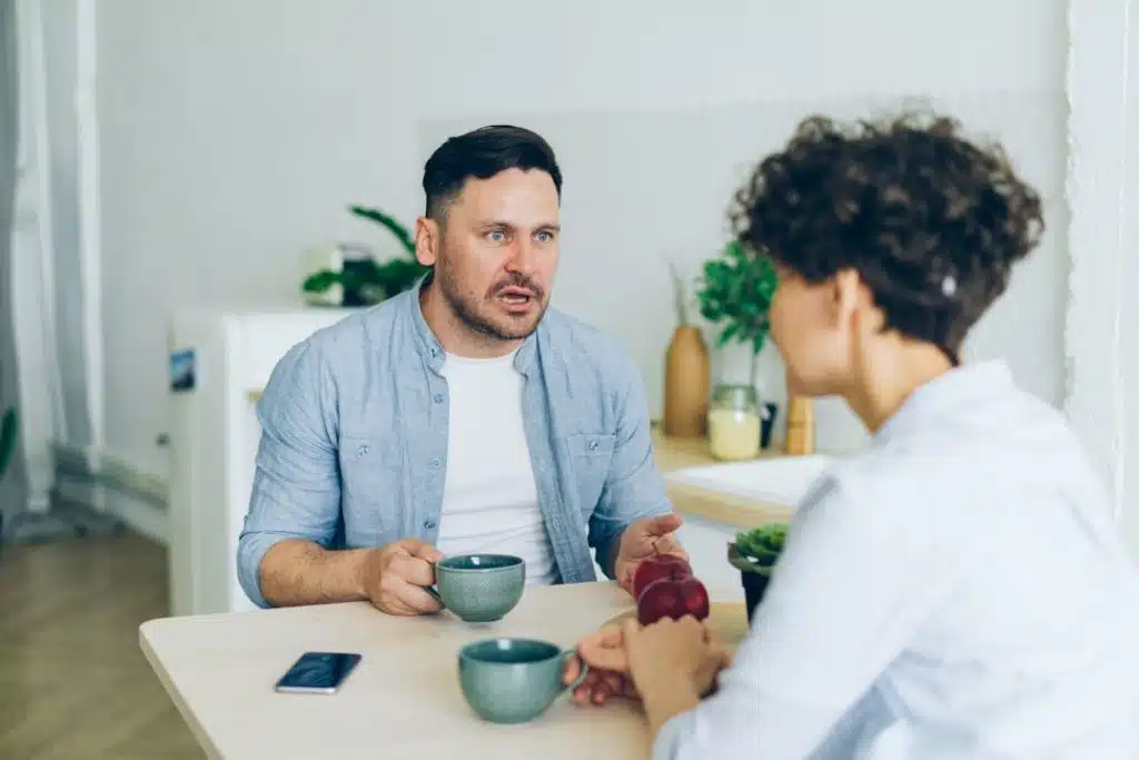 A man engaged in a one-on-one therapy session with a counselor - Men's inpatient rehab