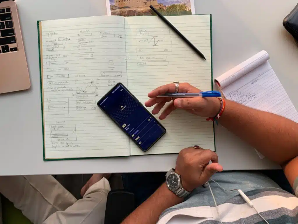 Person on the phone, taking notes on a notepad - Suboxone doctor search
