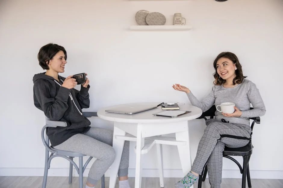 Two people talking over coffee, representing a sponsor and sponsee relationship - 12 Step Program