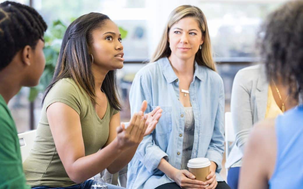 Group therapy session in a bright, modern room - san antonio alcohol treatment centers Group therapy session in a bright, modern room - san antonio alcohol treatment centers