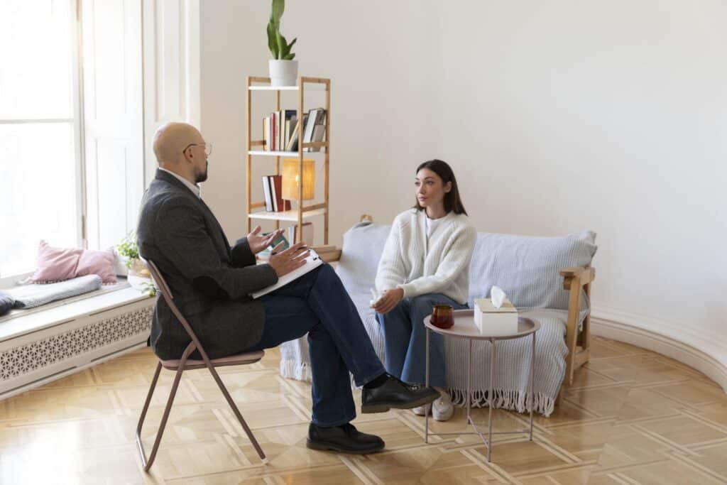 A counselor and patient engage in a one-on-one therapy session - medically assisted treatment