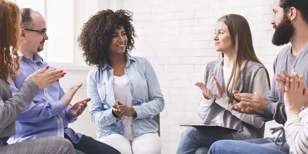 A diverse group of people participating in a support meeting, symbolizing community and shared recovery - heroin addiction help A diverse group of people participating in a support meeting, symbolizing community and shared recovery - heroin addiction help