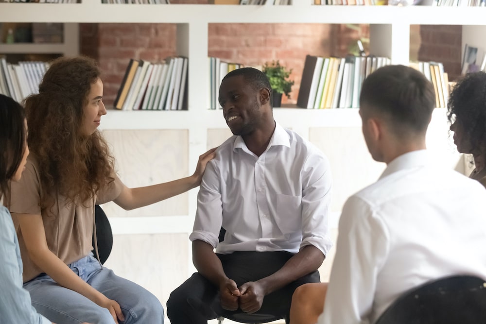 Diverse group of people in a support meeting - helplines for substance abuse