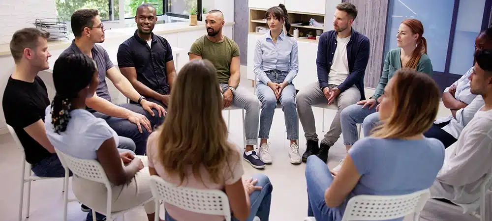 A diverse group of people in a supportive setting - outpatient drug treatment A diverse group of people in a supportive setting - outpatient drug treatment