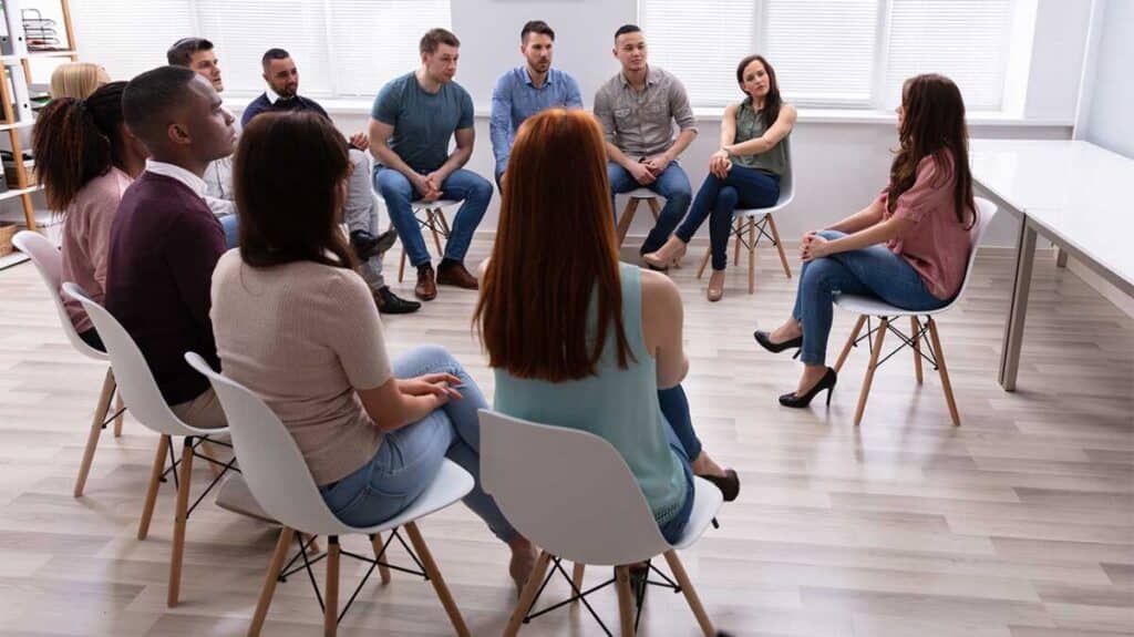 diverse group of people in a supportive therapy circle - Outpatient alcohol treatment diverse group of people in a supportive therapy circle - Outpatient alcohol treatment