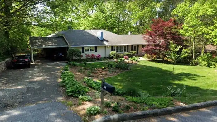 Main entrance of Tender Loving Care Home in Asheville, North Carolina, showing the facility providing residential addiction recovery and support services.