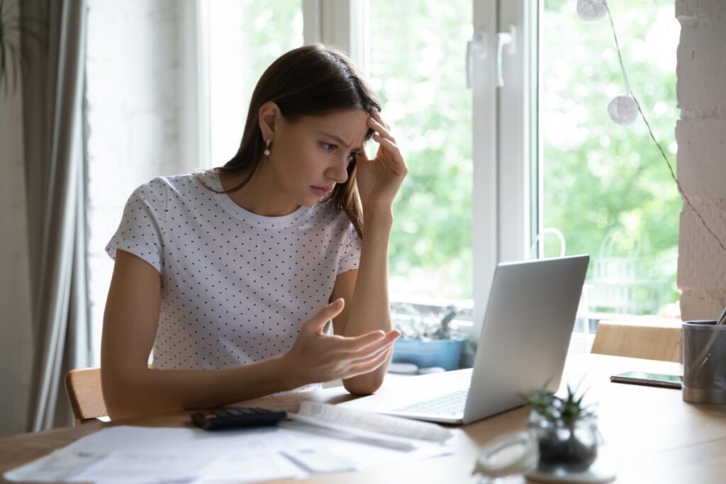 A person balancing work on a laptop and a therapy workbook - outpatient rehab Arizona