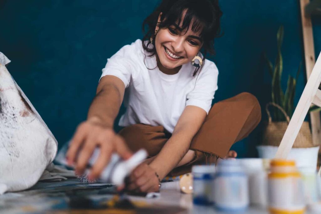 person enjoying a new, healthy hobby like hiking or painting - aftercare for addiction