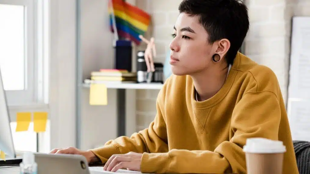 Person on a laptop, researching and looking thoughtful - LGBTQ inpatient rehab Person on a laptop, researching and looking thoughtful - LGBTQ inpatient rehab