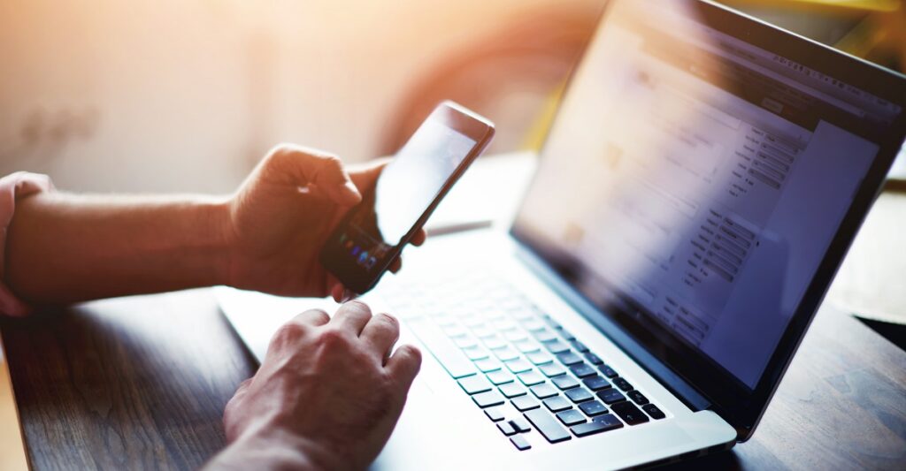 Person using a laptop to search for local mental health resources - mental health clinic Person using a laptop to search for local mental health resources - mental health clinic