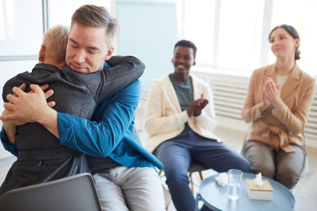 A professional interventionist speaking calmly with a family, guiding them through the process - how to stage intervention A professional interventionist speaking calmly with a family, guiding them through the process - how to stage intervention