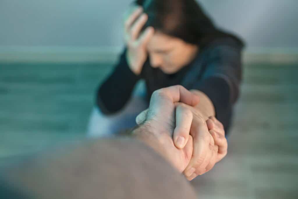 person reaching for a helping hand - help for drug addiction
