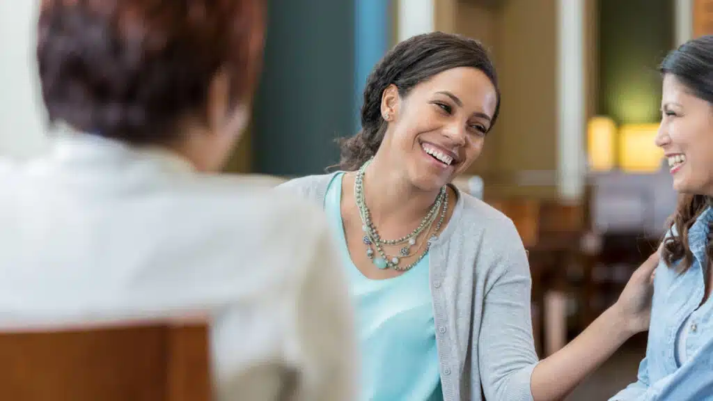 Group of people in a support meeting, smiling and engaged - detox centers Group of people in a support meeting, smiling and engaged - detox centers