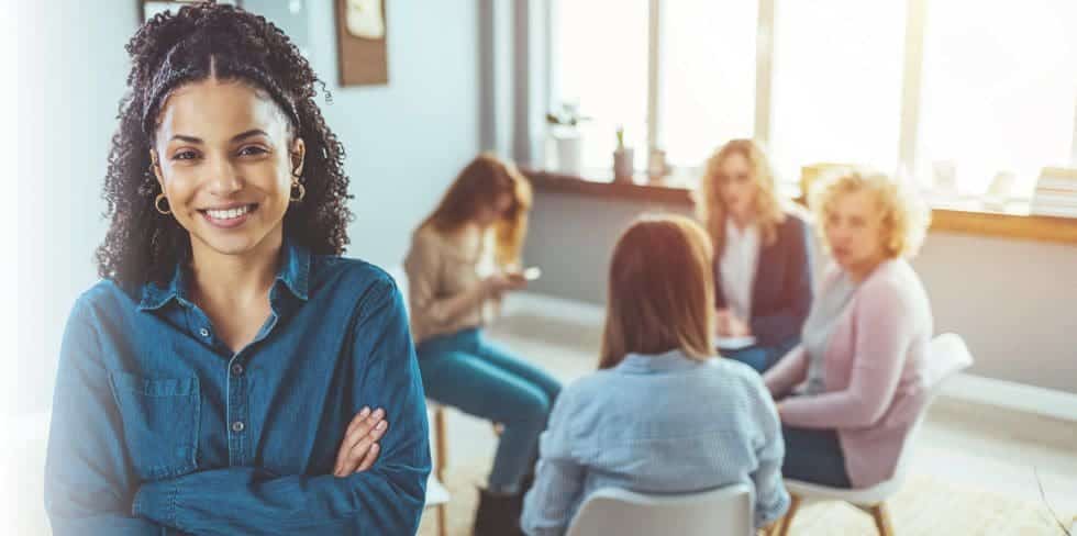 A diverse group of people engaged in a supportive group therapy session, seated in a circle, some speaking while others listen attentively, symbolizing community and shared recovery - Alcohol & Drug Rehabs in Morristown, Tennessee