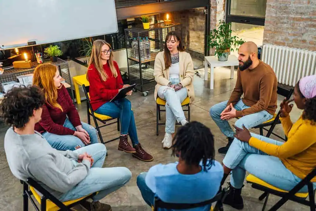 A diverse group of individuals engaged in a supportive group therapy session, actively listening and participating. - outpatient rehab programs in scottsdale A diverse group of individuals engaged in a supportive group therapy session, actively listening and participating. - outpatient rehab programs in scottsdale