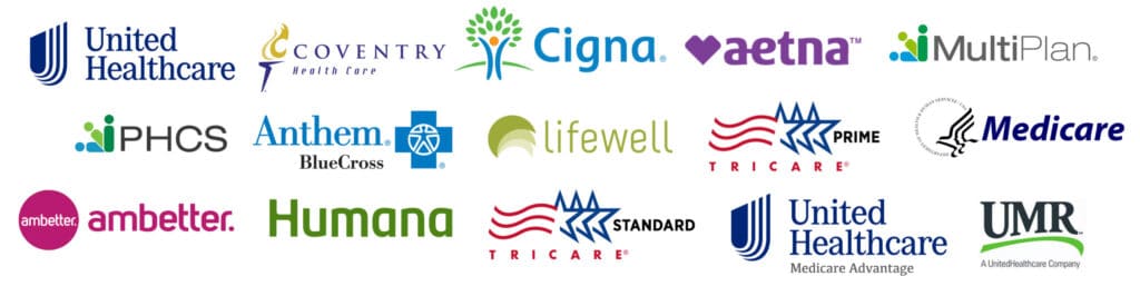 A person's hands reviewing insurance documents and a pen, with a calculator and glasses on a wooden desk, symbolizing financial planning for healthcare - Alcohol & Drug Rehabs in Morristown, Tennessee